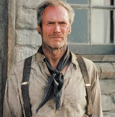 Clint Eastwood jako Brudny Harry, trzymający rewolwer .44 Magnum, z zaciętym wyrazem twarzy w miejskim otoczeniu.